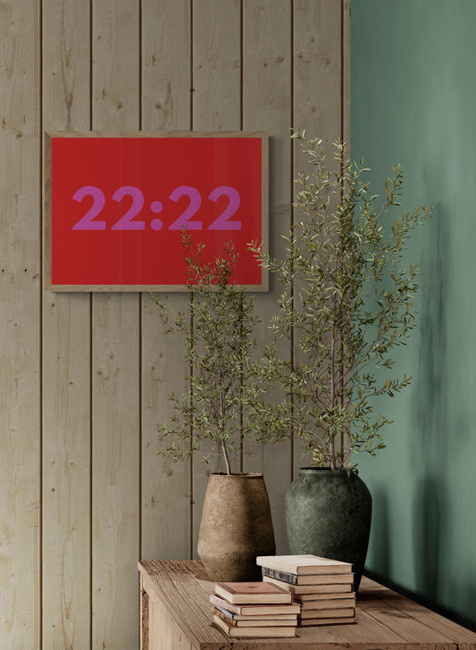 Red digital clock displaying angel time '22:22' in a room with wooden walls, plants, and books.