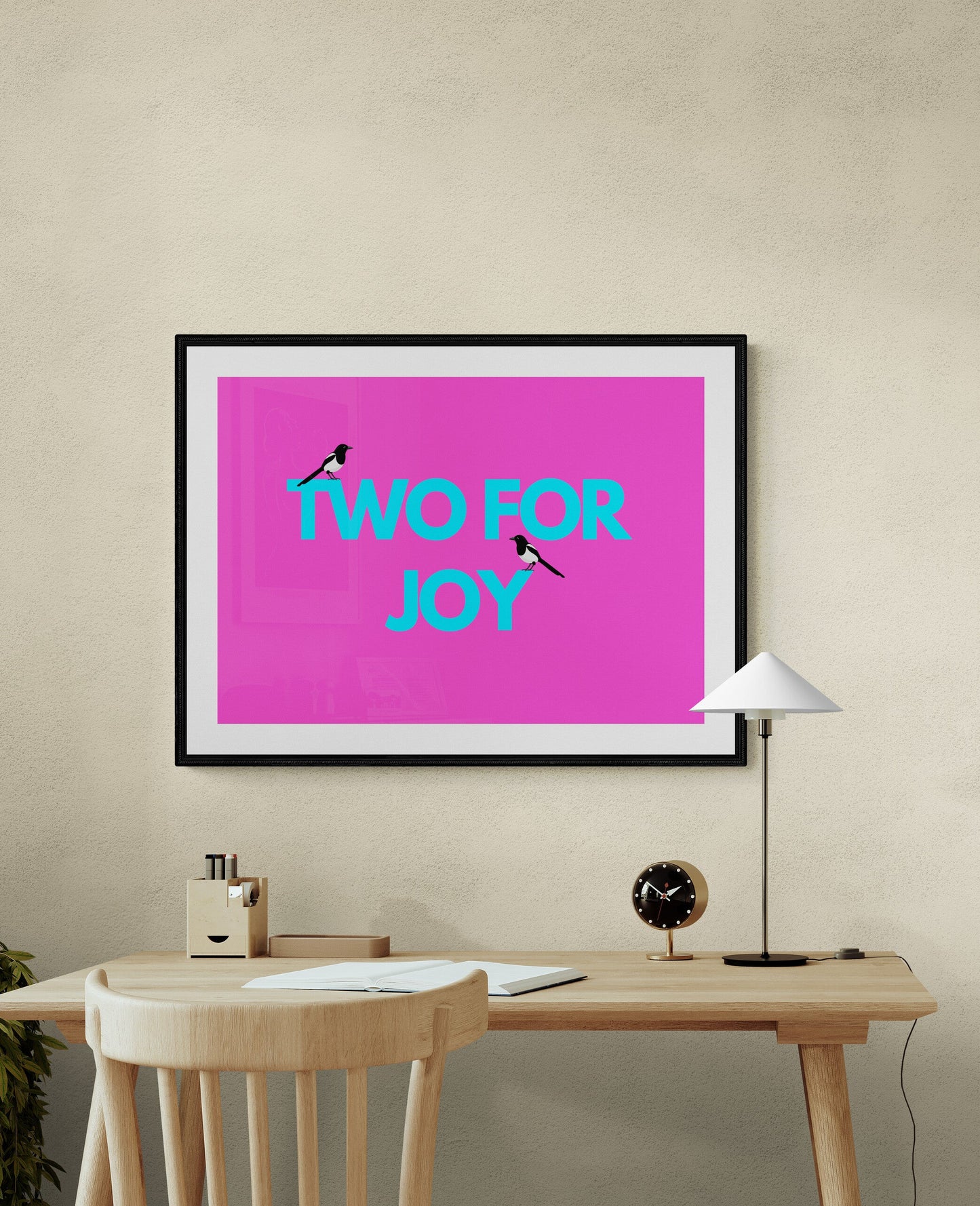 Two for Joy magpie art poster in bold dopamine colours framed above desk
