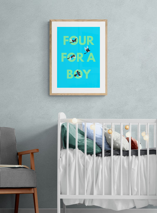 A framed art print with the text 'FOUR magpieS for a BOY' hanging on a wall above a white crib, with a wooden chair and a framed picture to the left.