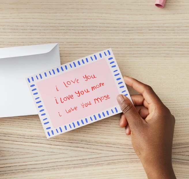 Card with kids writing saying i love you i love you more i love you most with a blue stripey border