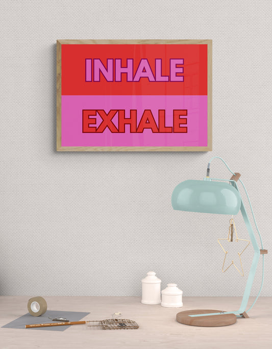 Red and pink framed artwork with inhale / exhale text for a home office or yoga studio.