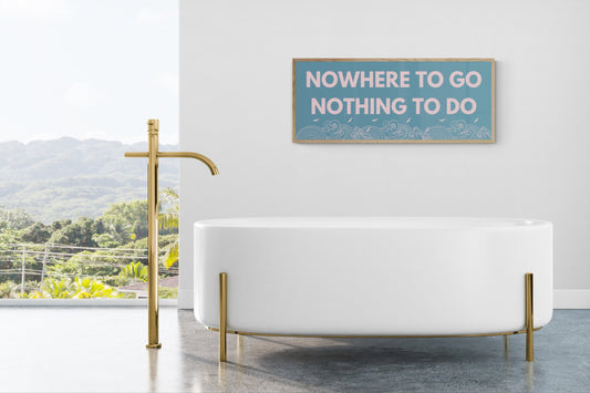 nowhere to go nothing to do print framed above a bath perfect for quiet spaces