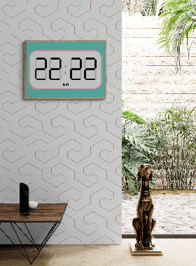 Digital clock wall art print with 22:22 on a wall with a decorative pattern, a table with a small plant, and a statue of a dog in a room.