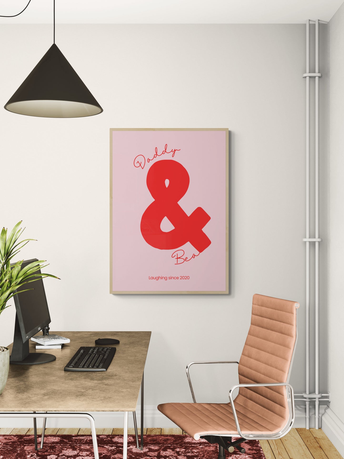 Modern office setup with a pink personalised fathers day poster featuring a red ampersand, beige chair, and desk.