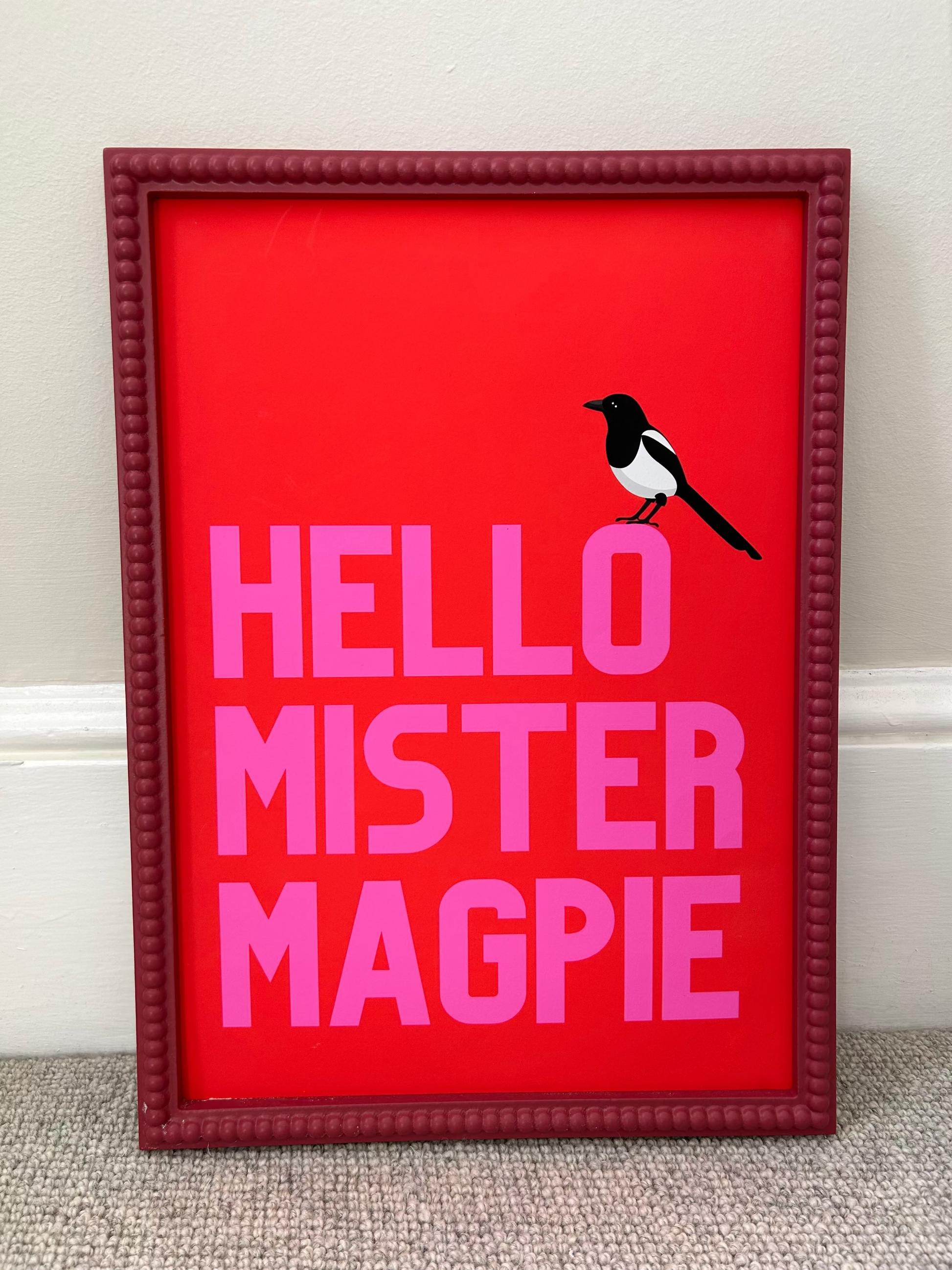 bright bold dopamine print with one magpie perched on the text hello mister magpie 