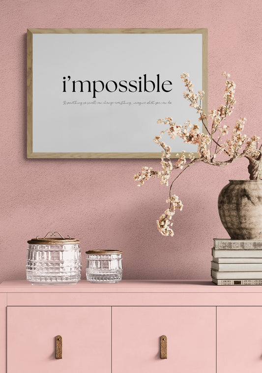 Framed poster with 'i'mpossible' text on a pink wall with decorative elements. Wording underneath says if something so small can change everything imagine what you can do