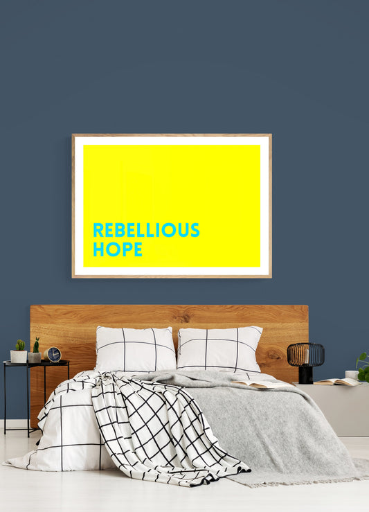 Bedroom with a 'Rebellious Hope' framed print on the wall.