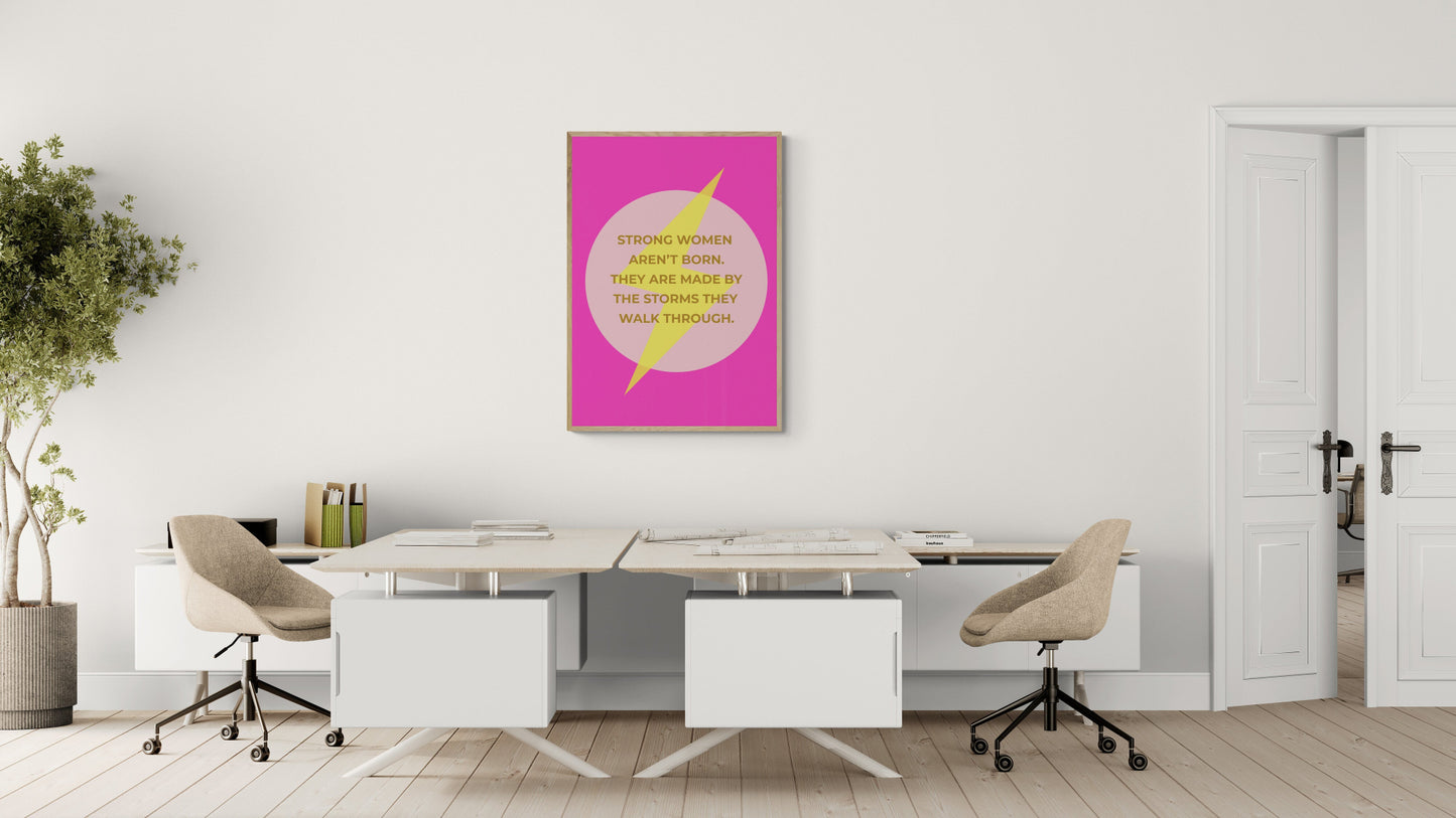 Modern office with a desk, chairs, and a motivational poster on the wall. Strong women aren't born. They are made by the storms they walk through wording on top of a lightening bolt on a bright pink dopamine background.