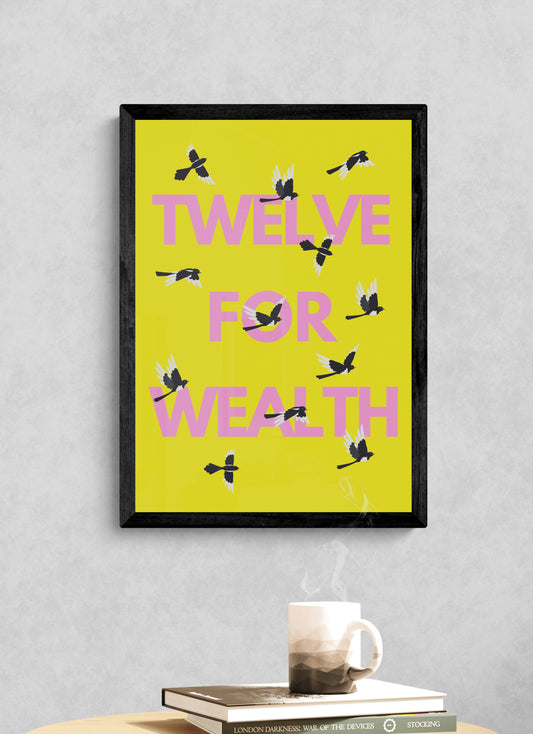 Framed artwork with 'Twelve for Wealth' text and twelve magpies positioned on a yellow background, placed on a table against a gray wall.