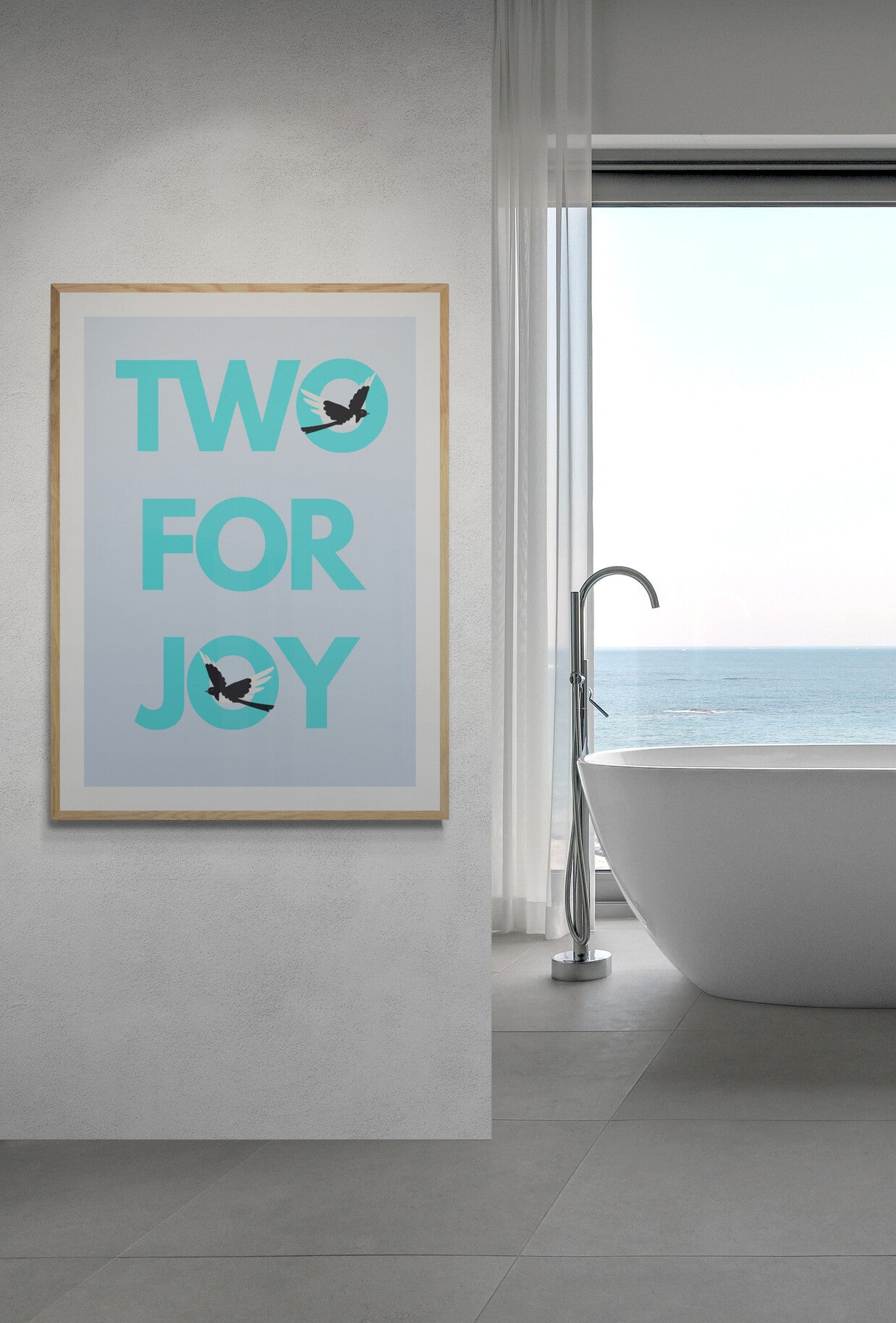 Bathroom with a bathtub and a framed poster with 'TWO FOR JOY' text and magpies in coastal colours 