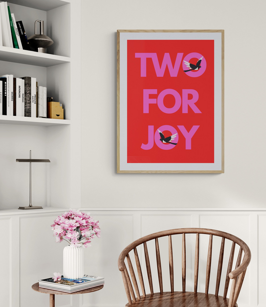 Wooden chair in a room with a 'Two for Joy' poster with two magpies on it on the wall signifying good lucky